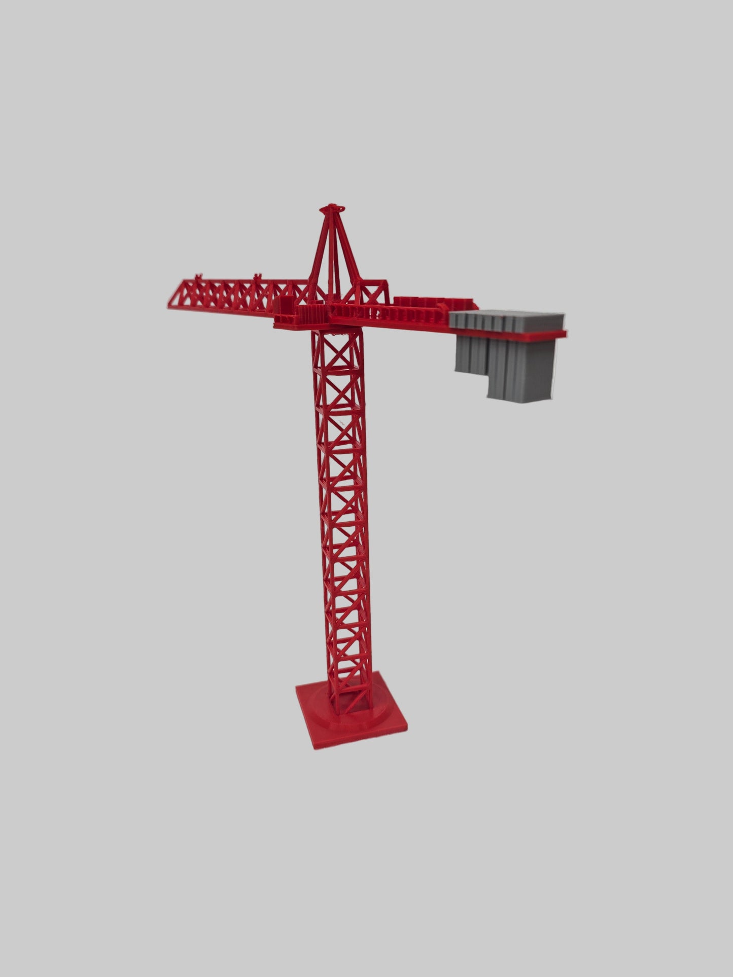 Red model crane on a textured white surface