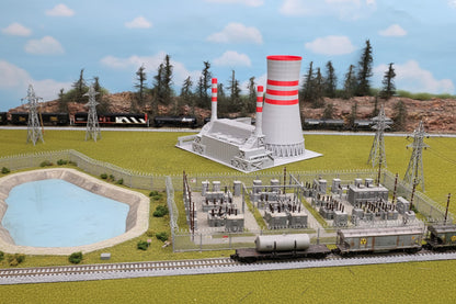 Model of a power plant with transmission lines and a train in the background
