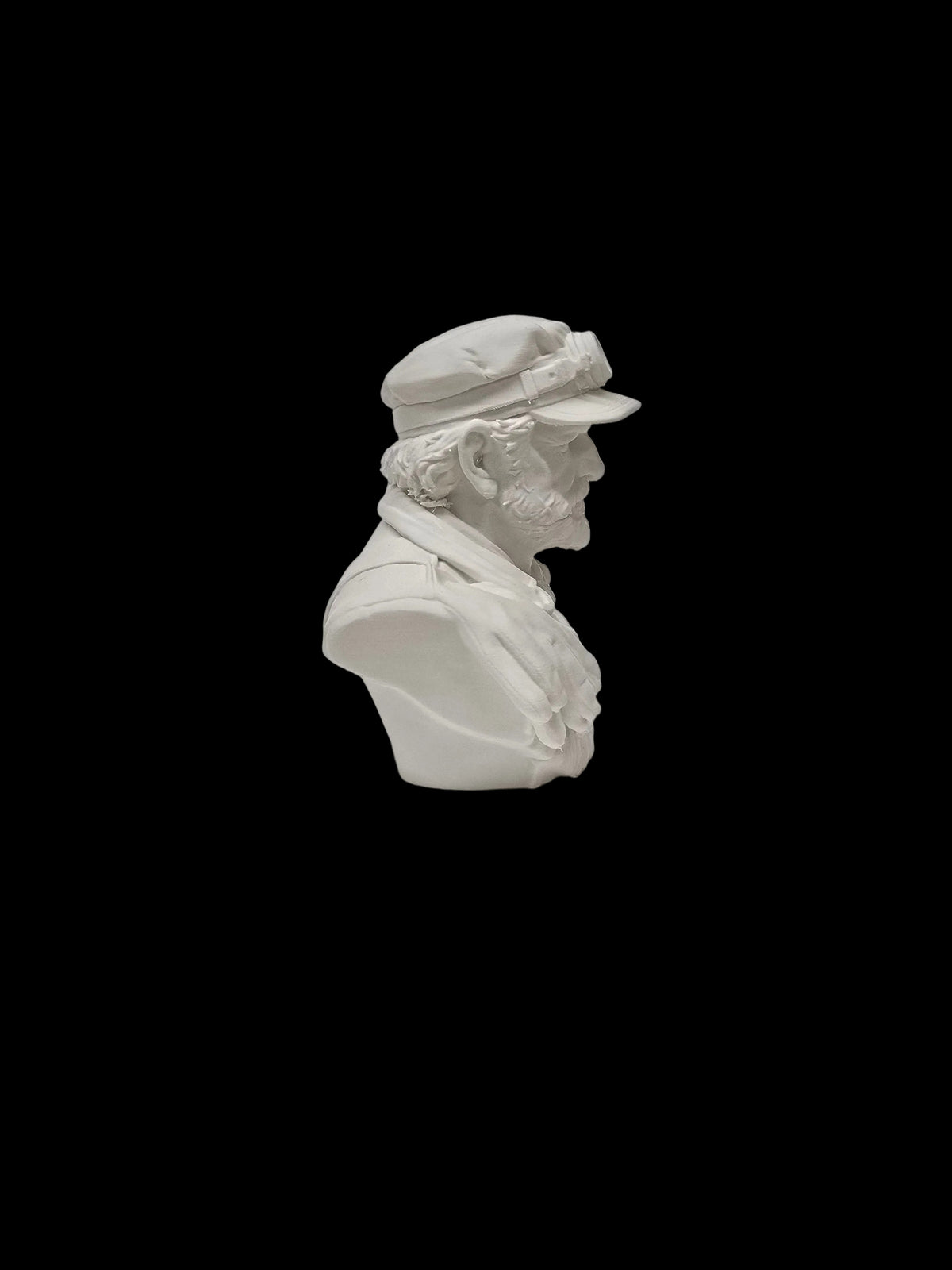 A white resin or ceramic bust sculpture of an elderly man in profile, wearing a cap and jacket, set against a textured white background.