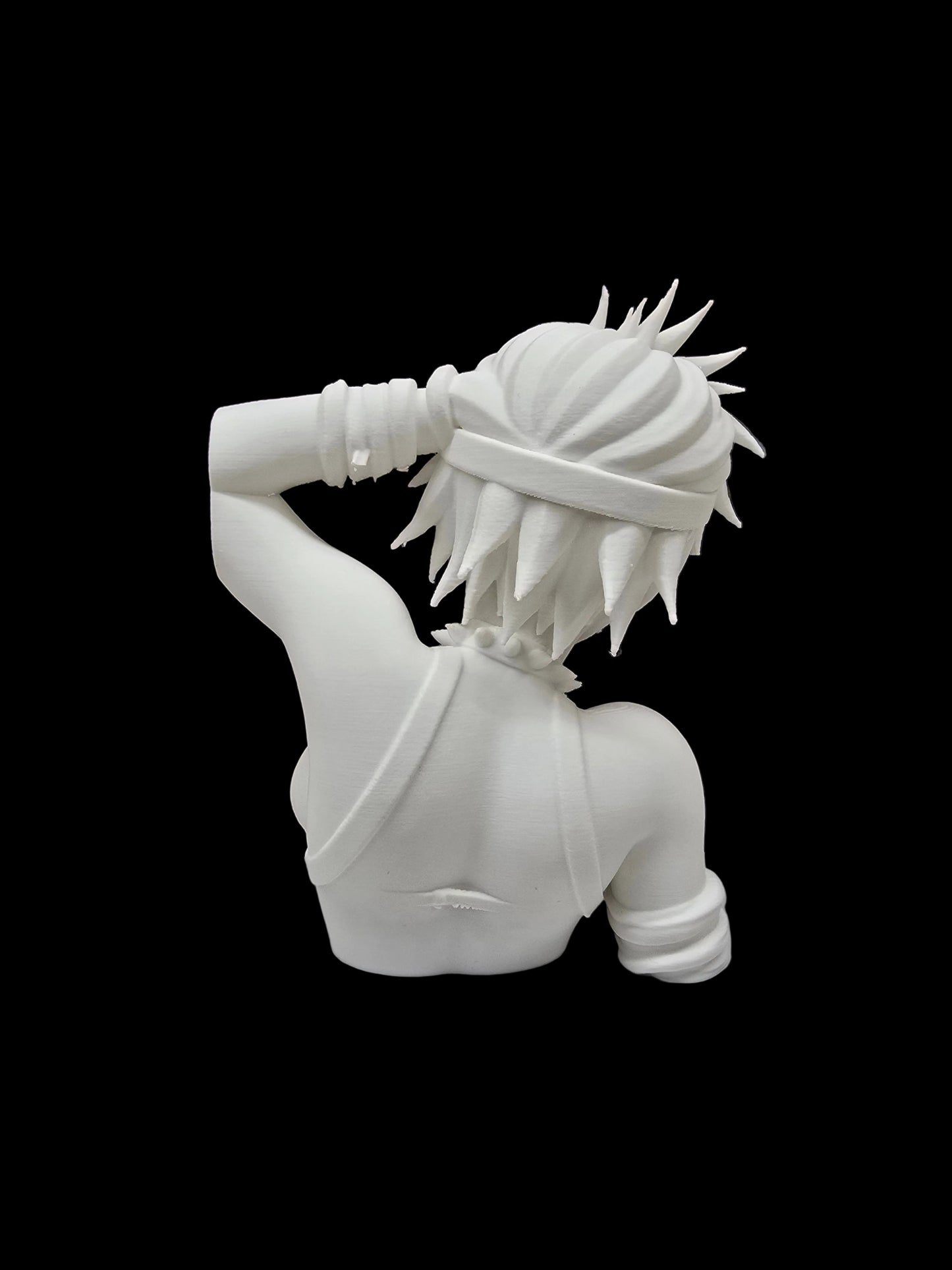 A white resin figurine of a female anime character with spiky hair, shown from behind, standing on a white display base in front of a brown bookshelf filled with books.