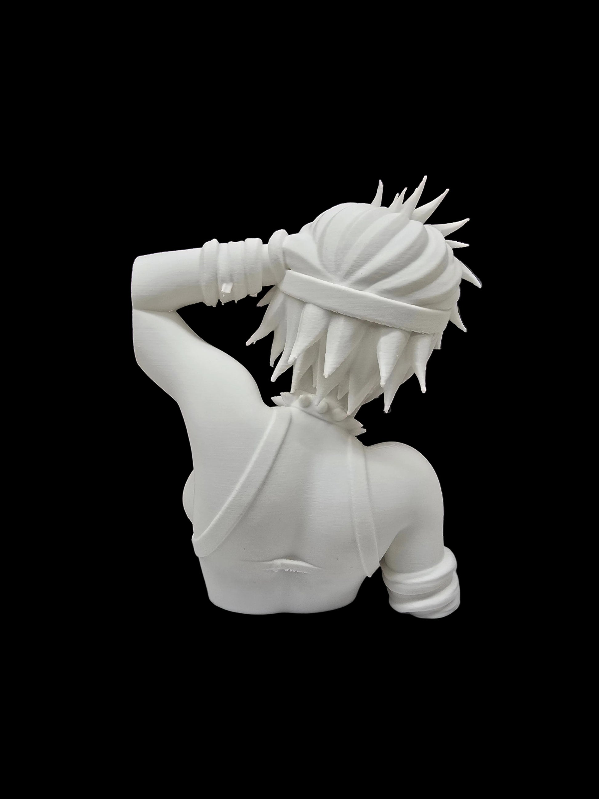 A white resin figurine of a female anime character with spiky hair, shown from behind, standing on a white display base in front of a brown bookshelf filled with books.