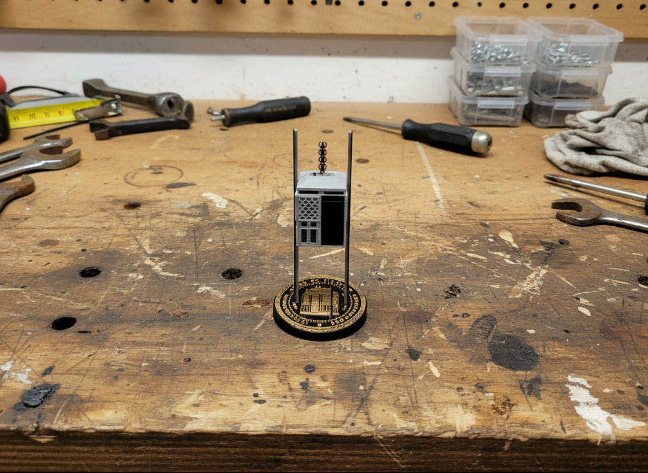 Small model of a building on a textured white surface