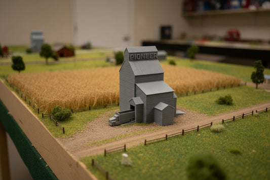 Model of a grain elevator with 'Pioneer' branding on a white surface