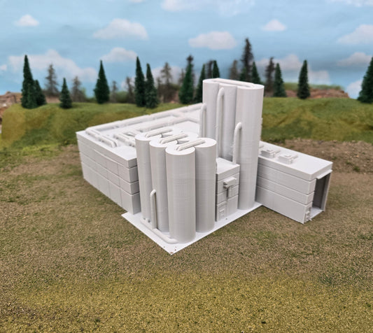 Model of a building on a grassy area with trees in the background