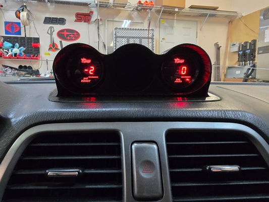 Digital speedometer and tachometer display on a car dashboard with a garage background.