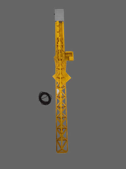 Yellow crane model on a gray square platform with tools on a light gray background